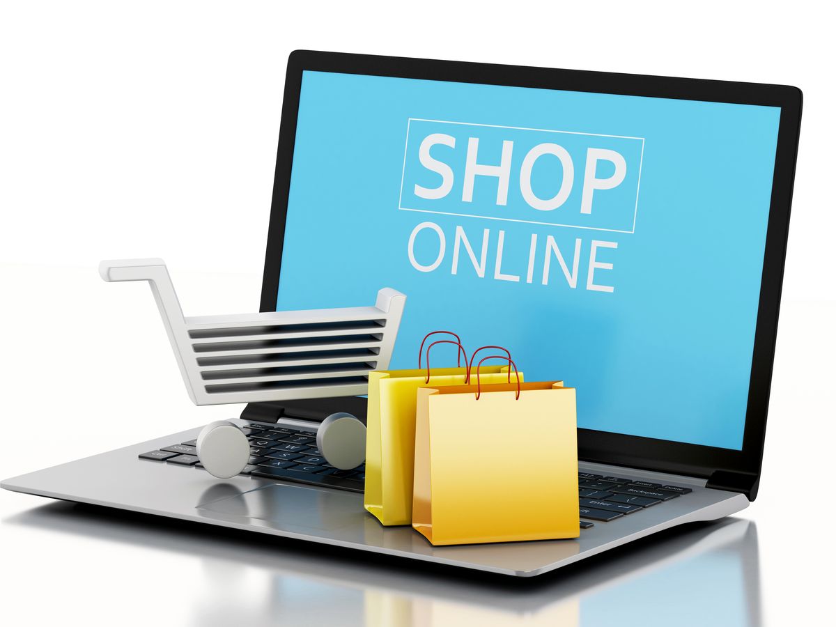 3d illustration. Shopping cart with bags on Laptop. Online shopping concept.